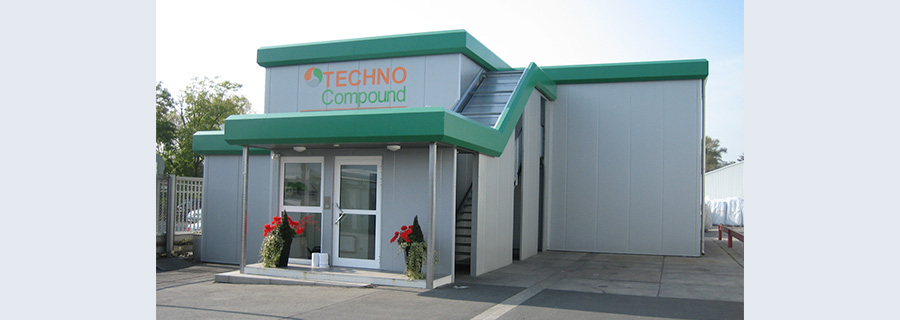 Grey building constructed from modules and containers by Novocont